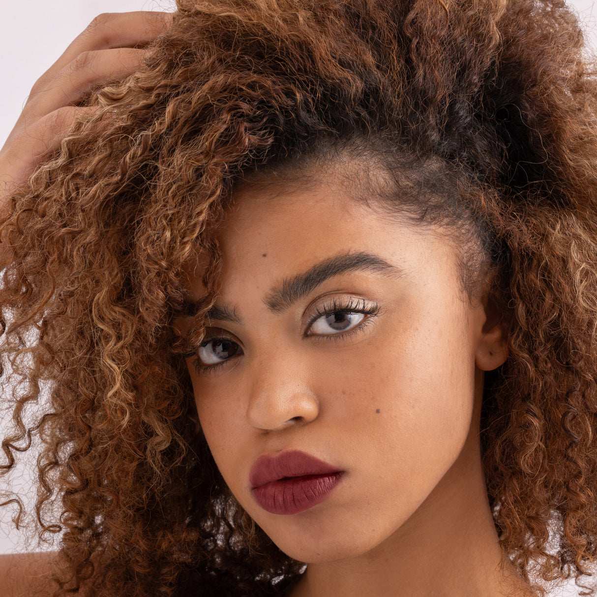 Model wearing Stained lip stain charming shade on a clean studio background.