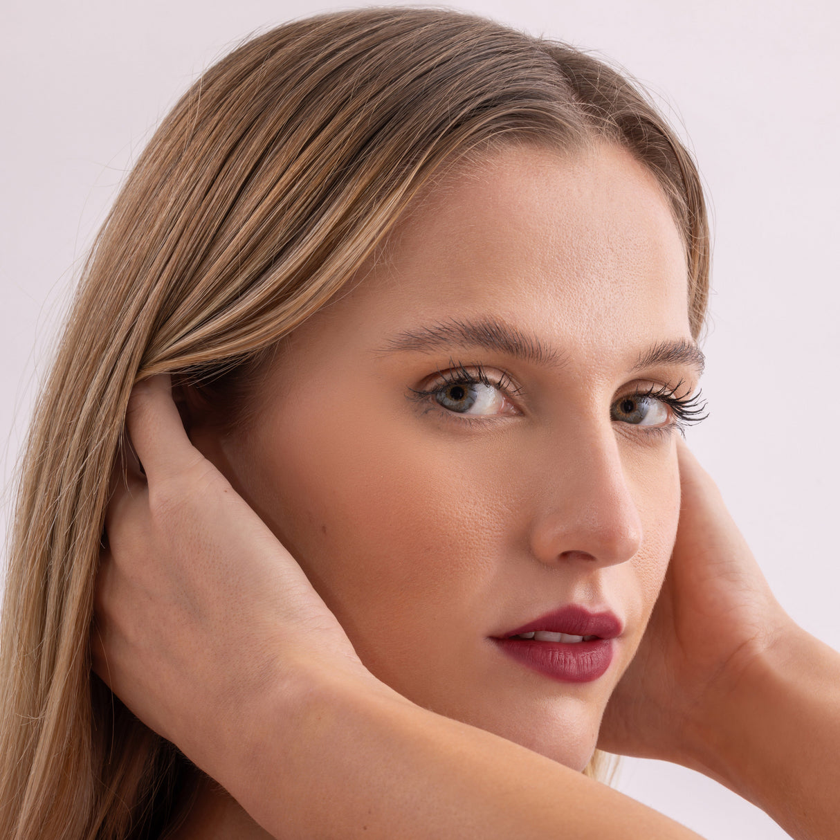 Model wearing Stained lip stain charming shade on a clean studio background.