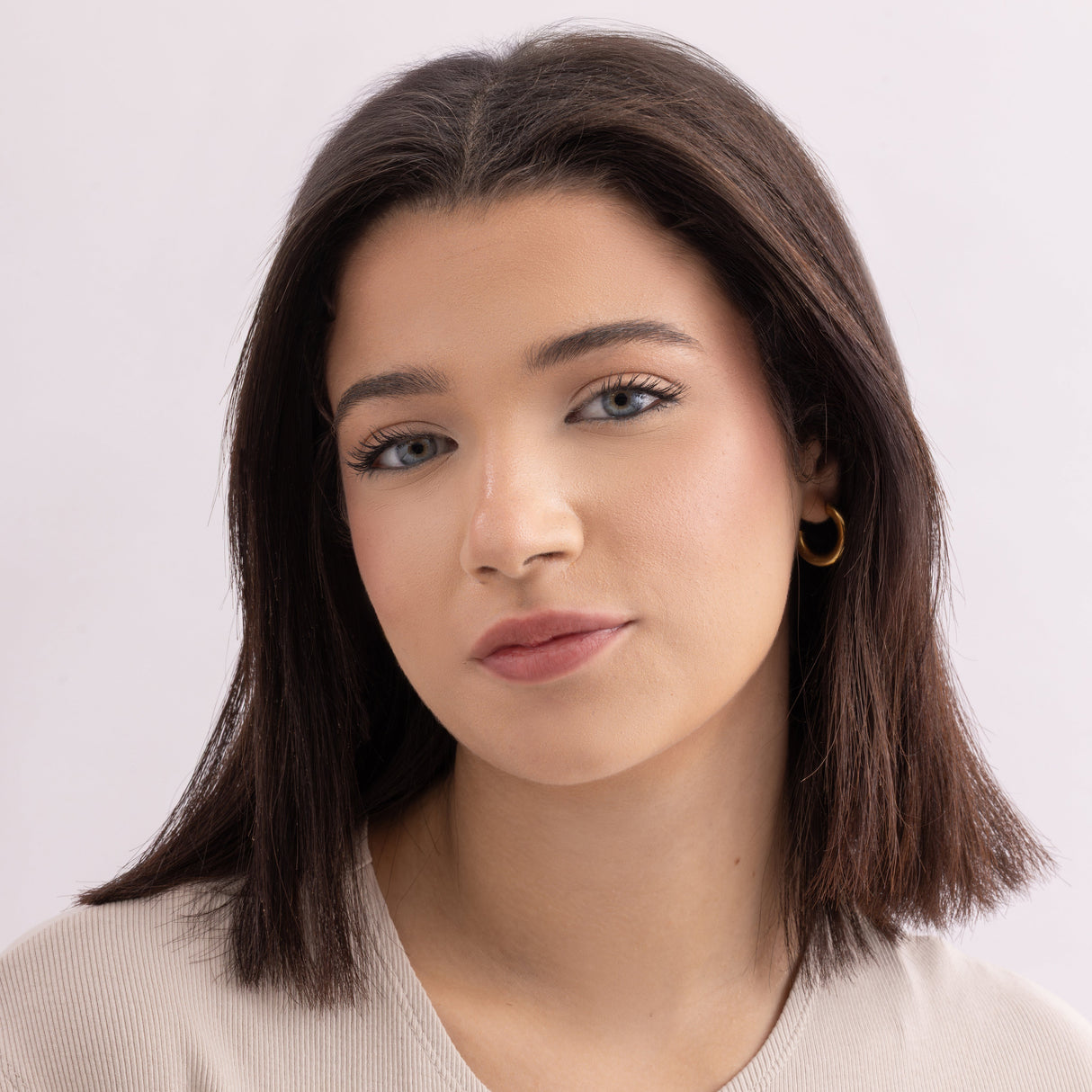 Model wearing Stained lip stain adore shade on a clean studio background.