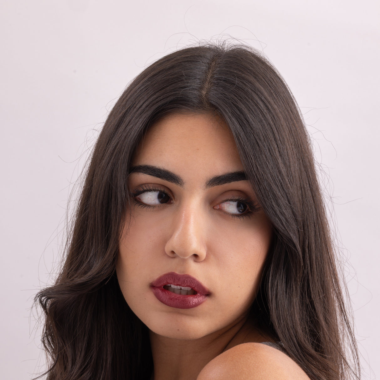 Model wearing Stained lip stain charming shade on a clean studio background.